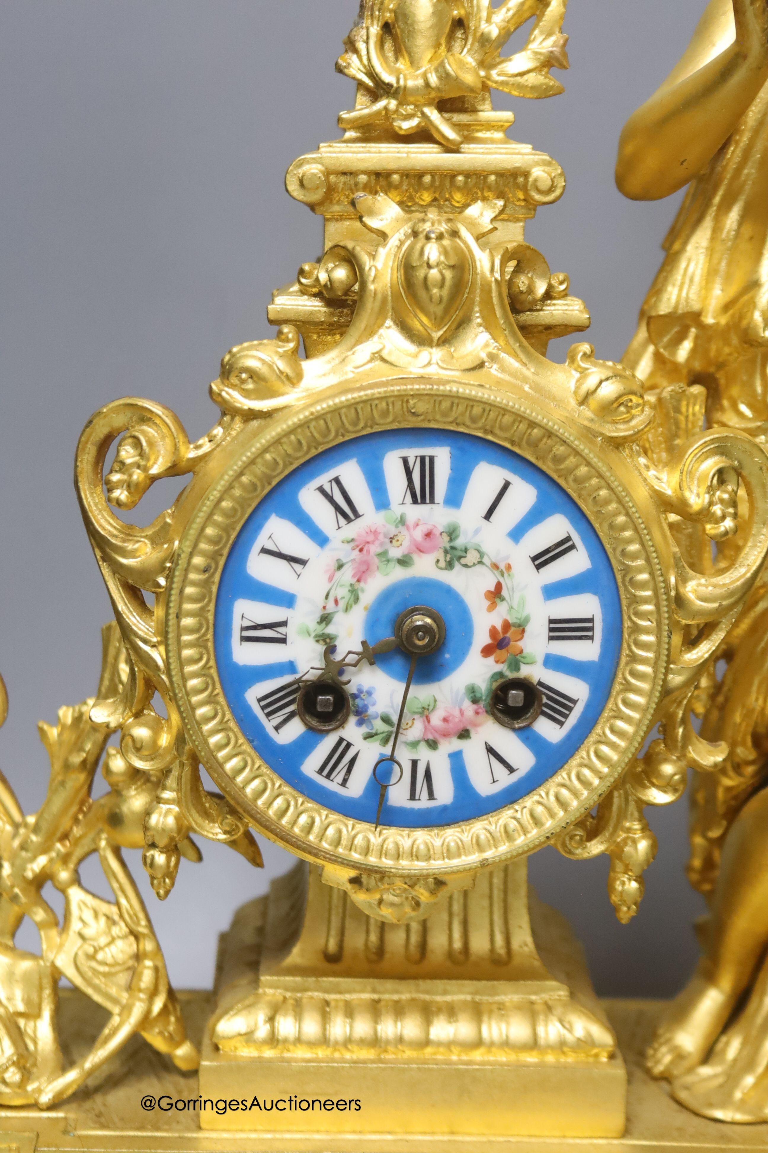 A late 19th century French gilt metal figural mantel clock, with Sevres style inserts, with key and pendulum, height 42cm